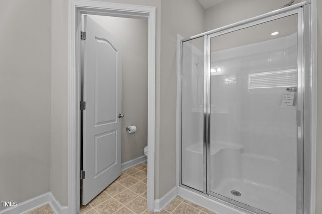 30 Sunbury Ct, Zebulon, NC 27597 - bathroom featuring a stall shower, baseboards, and toilet
