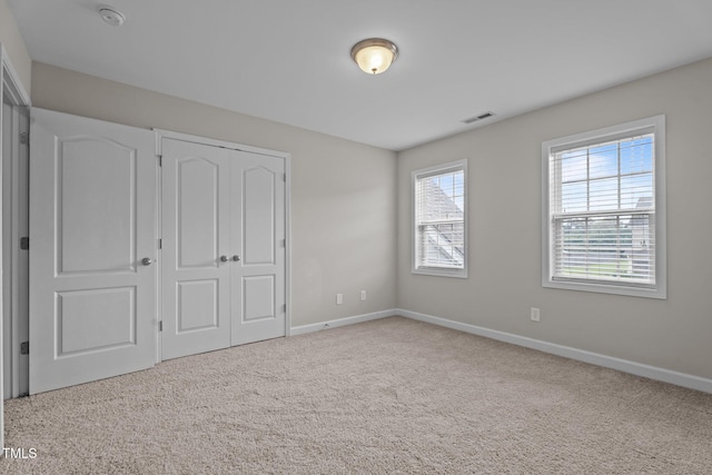 30 Sunbury Ct, Zebulon, NC 27597 - unfurnished bedroom featuring baseboards, carpet floors, and a closet