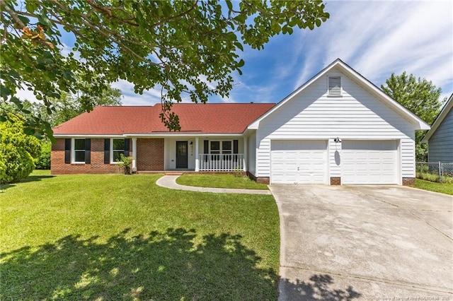 ranch-style home with driveway, a garage, and covered porch