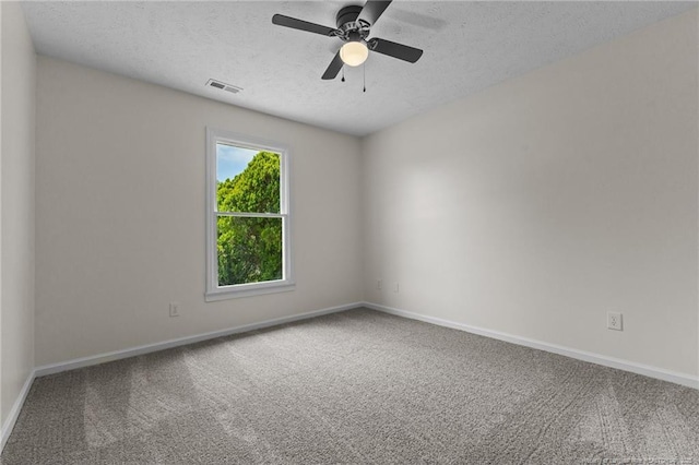 empty room featuring carpet flooring, baseboards, a textured ceiling, and ceiling fan