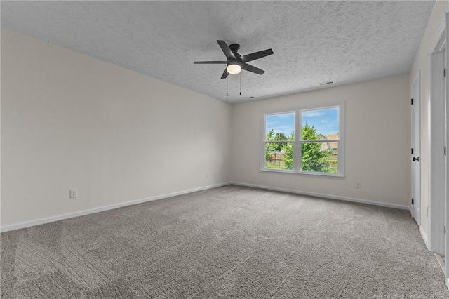 carpeted empty room with a ceiling fan, baseboards, and a textured ceiling
