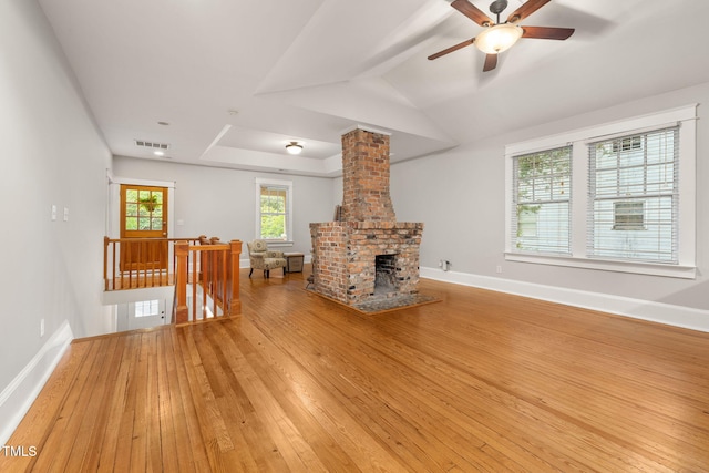 1008 Dorothea Dr, Raleigh, NC 27603 - unfurnished living room featuring light wood-type flooring, a ceiling fan, and baseboards