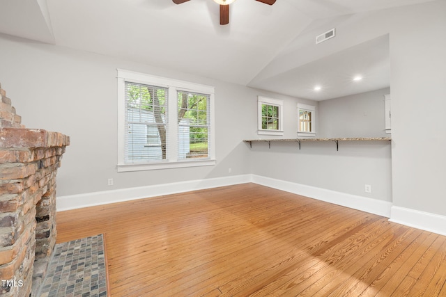 1008 Dorothea Dr, Raleigh, NC 27603 - unfurnished living room with wood-type flooring, a ceiling fan, vaulted ceiling, and baseboards