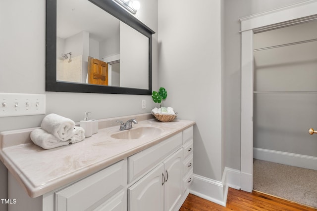 1008 Dorothea Dr, Raleigh, NC 27603 - bathroom featuring vanity, baseboards, and wood finished floors
