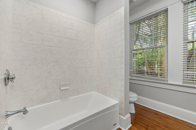 1008 Dorothea Dr, Raleigh, NC 27603 - bathroom featuring toilet, wood finished floors, bathtub / shower combination, and baseboards