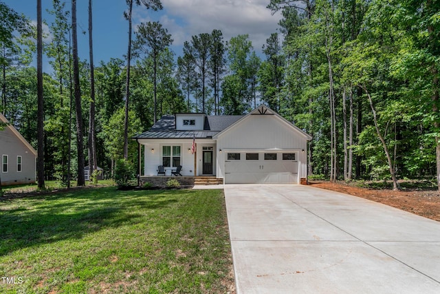 136 Hatchet Cv, Louisburg, NC 27549 - modern farmhouse style home featuring a porch, a garage, concrete driveway, a front lawn, and board and batten siding