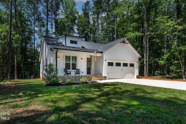 136 Hatchet Cv, Louisburg, NC 27549 - modern inspired farmhouse featuring covered porch, driveway, an attached garage, and a front lawn