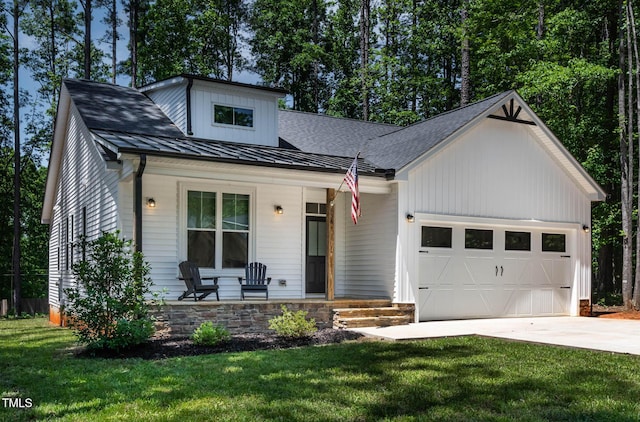 136 Hatchet Cv, Louisburg, NC 27549 - modern inspired farmhouse with a porch, a garage, concrete driveway, a front lawn, and a standing seam roof