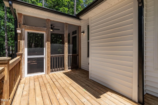 136 Hatchet Cv, Louisburg, NC 27549 - deck featuring view of scattered trees, a sunroom, and a ceiling fan