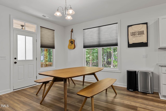 136 Hatchet Cv, Louisburg, NC 27549 - dining space with healthy amount of natural light, dark wood-type flooring, and a chandelier