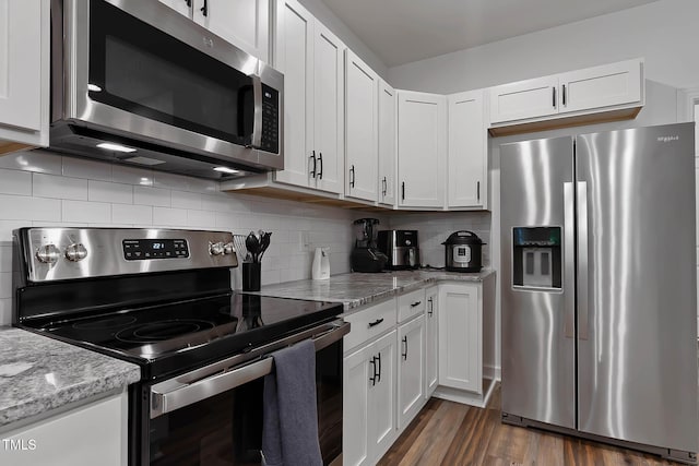 136 Hatchet Cv, Louisburg, NC 27549 - kitchen featuring stainless steel appliances, white cabinetry, and tasteful backsplash