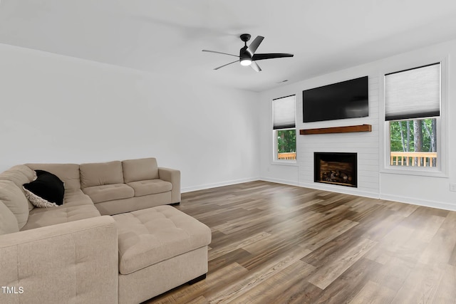 136 Hatchet Cv, Louisburg, NC 27549 - living room with a ceiling fan, wood finished floors, baseboards, and a fireplace