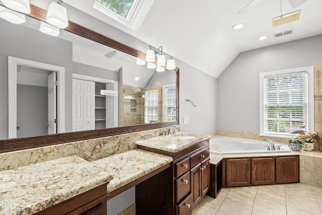 1007 Surry Dale Ct, Apex, NC 27502 - bathroom with a tile shower, healthy amount of natural light, a garden tub, lofted ceiling, and a skylight