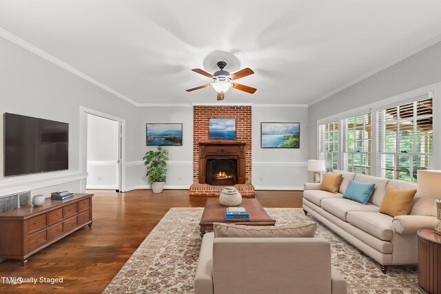 1007 Surry Dale Ct, Apex, NC 27502 - living room with a ceiling fan, dark wood-style floors, ornamental molding, a fireplace, and baseboards