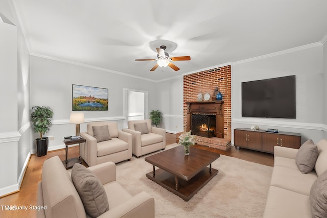 1007 Surry Dale Ct, Apex, NC 27502 - living area with light wood-style floors, ceiling fan, crown molding, and a fireplace