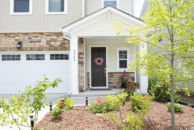 2264 Jollay St, Durham, NC 27703 - property entrance featuring stone siding and an attached garage