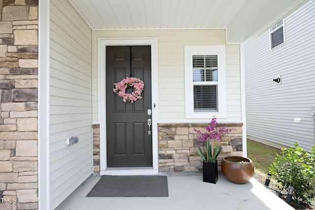 2264 Jollay St, Durham, NC 27703 - view of exterior entry featuring stone siding and covered porch