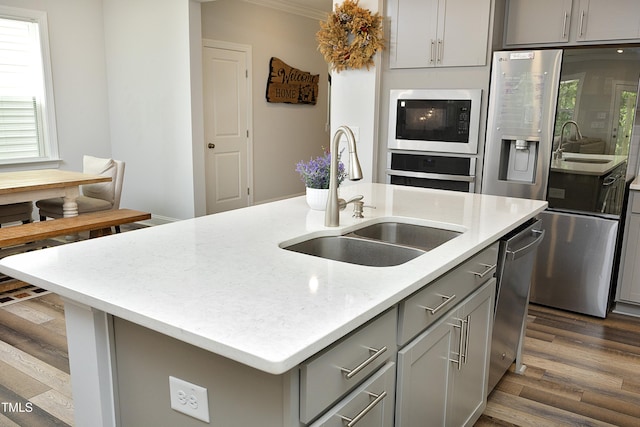 2264 Jollay St, Durham, NC 27703 - kitchen featuring gray cabinetry, appliances with stainless steel finishes, a sink, and ornamental molding