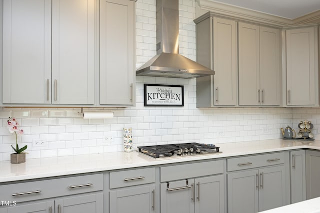 2264 Jollay St, Durham, NC 27703 - kitchen with gray cabinetry, wall chimney range hood, stainless steel gas cooktop, decorative backsplash, and light countertops