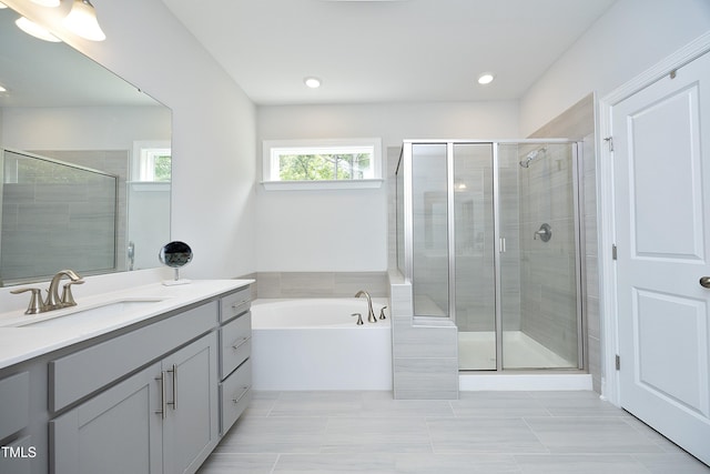 2264 Jollay St, Durham, NC 27703 - bathroom featuring vanity, a stall shower, a bath, and recessed lighting