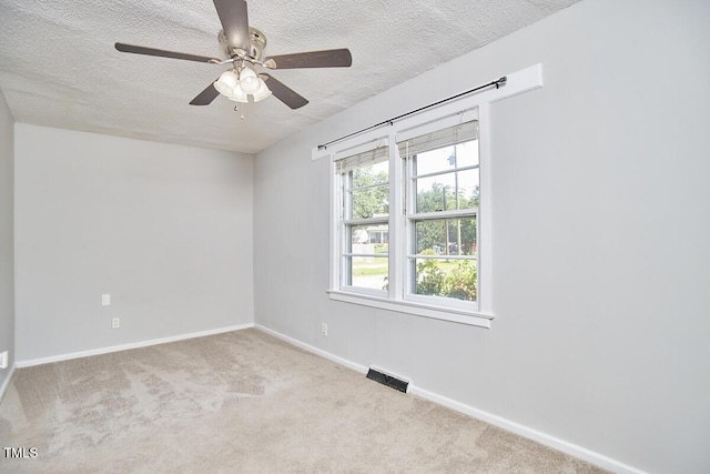 2616 Kirk Rd, Durham, NC 27705 - empty room featuring a textured ceiling, a ceiling fan, carpet, and baseboards