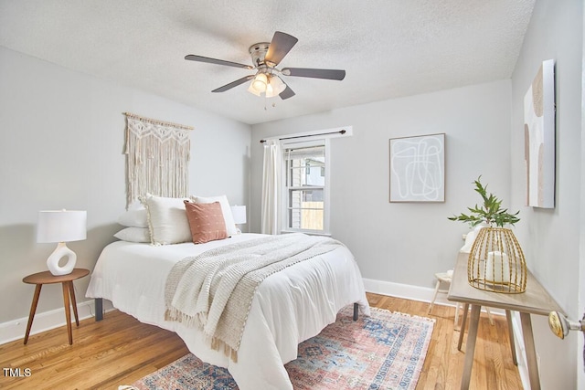 2616 Kirk Rd, Durham, NC 27705 - bedroom with light wood-type flooring, baseboards, a textured ceiling, and a ceiling fan