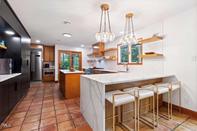 500 Walnut Creek Dr, Goldsboro, NC 27534 - kitchen with open shelves, premium appliances, a peninsula, decorative backsplash, and baseboards