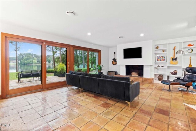 500 Walnut Creek Dr, Goldsboro, NC 27534 - living area featuring healthy amount of natural light, built in shelves, recessed lighting, and a fireplace with raised hearth