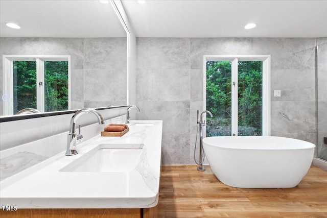 500 Walnut Creek Dr, Goldsboro, NC 27534 - full bathroom with tile walls, a soaking tub, double vanity, wood finished floors, and recessed lighting