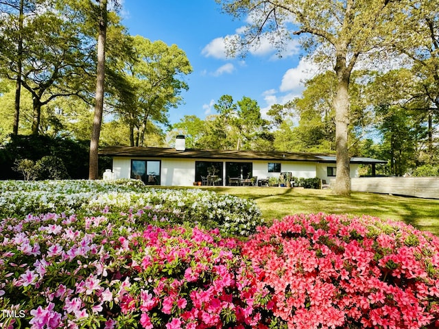500 Walnut Creek Dr, Goldsboro, NC 27534 - rear view of property with a chimney, a yard, and an attached carport
