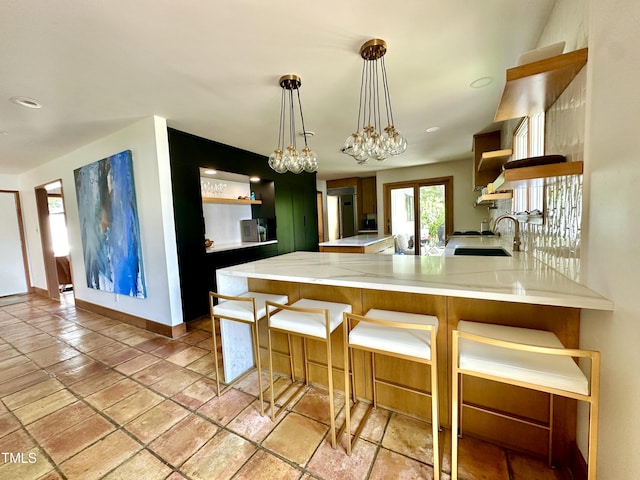 500 Walnut Creek Dr, Goldsboro, NC 27534 - kitchen featuring open shelves, light countertops, a peninsula, a sink, and recessed lighting
