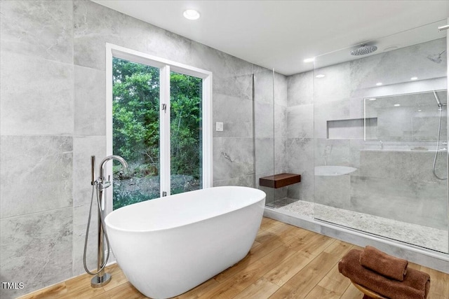 500 Walnut Creek Dr, Goldsboro, NC 27534 - bathroom featuring a soaking tub, tiled shower, and wood finished floors
