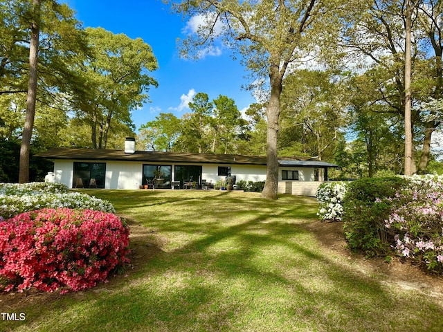 500 Walnut Creek Dr, Goldsboro, NC 27534 - back of house featuring a lawn and a chimney