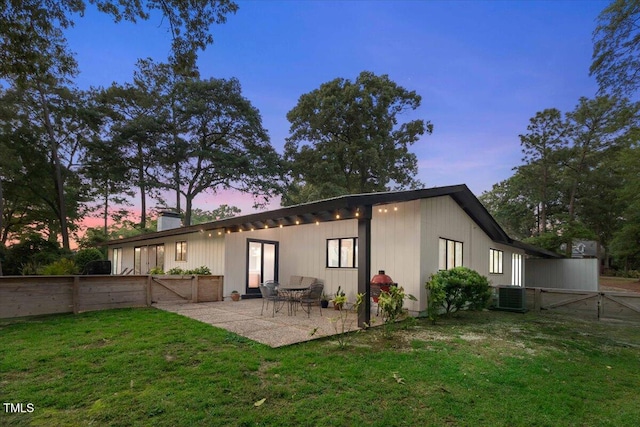 500 Walnut Creek Dr, Goldsboro, NC 27534 - back of house at dusk with a patio area, central AC unit, a chimney, and a gate