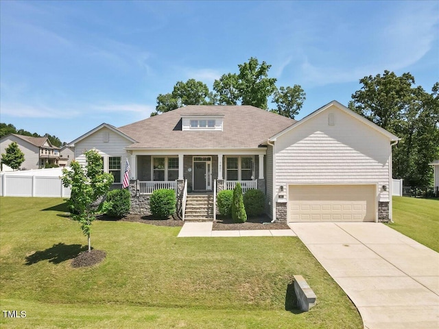 7801 Charters End St, Willow Springs, NC 27592 - view of front of house with covered porch, driveway, a garage, and stone siding