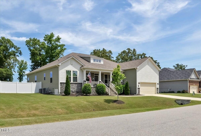 7801 Charters End St, Willow Springs, NC 27592 - view of front of property featuring covered porch, stone siding, driveway, and cooling unit