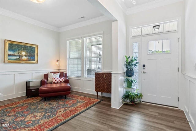 7801 Charters End St, Willow Springs, NC 27592 - entryway with healthy amount of natural light, a decorative wall, wood finished floors, wainscoting, and ornamental molding