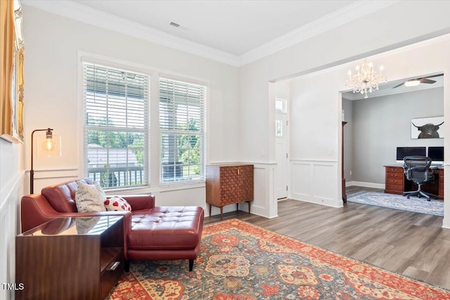 7801 Charters End St, Willow Springs, NC 27592 - living area featuring wood finished floors, crown molding, an office area, a chandelier, and a decorative wall