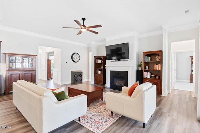 7801 Charters End St, Willow Springs, NC 27592 - living area featuring a ceiling fan, ornamental molding, a fireplace with flush hearth, wood finished floors, and baseboards
