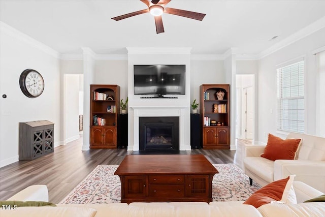 7801 Charters End St, Willow Springs, NC 27592 - living room with wood finished floors, a ceiling fan, crown molding, a fireplace with flush hearth, and baseboards