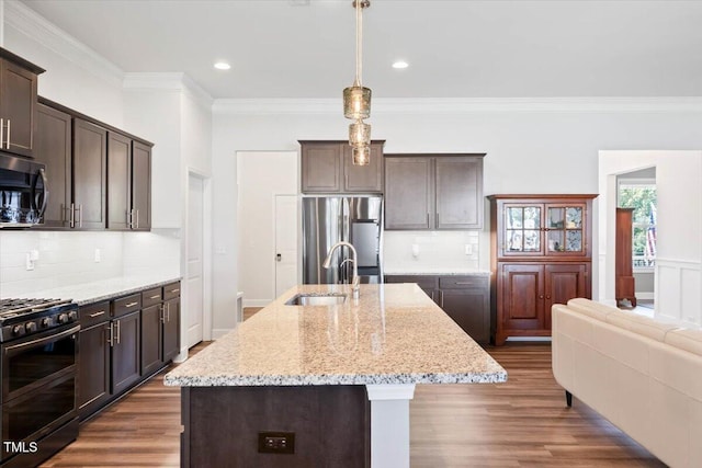 7801 Charters End St, Willow Springs, NC 27592 - kitchen featuring appliances with stainless steel finishes, a sink, dark brown cabinetry, crown molding, and dark wood-type flooring