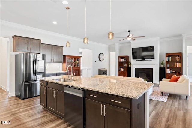 7801 Charters End St, Willow Springs, NC 27592 - kitchen featuring appliances with stainless steel finishes, a sink, ceiling fan, light wood-style flooring, and light stone countertops