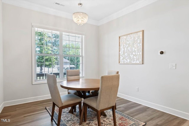 7801 Charters End St, Willow Springs, NC 27592 - dining room with ornamental molding, baseboards, a chandelier, and wood finished floors
