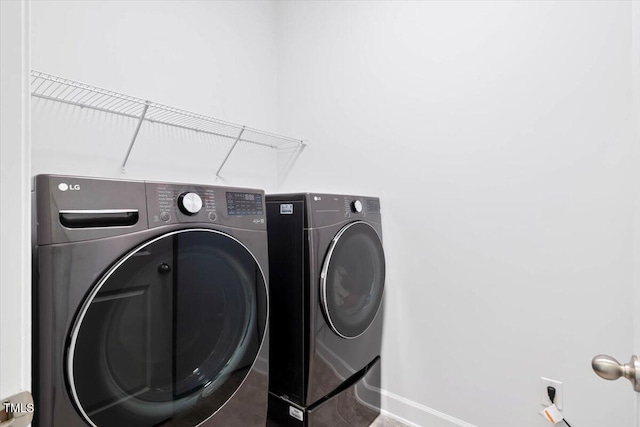 7801 Charters End St, Willow Springs, NC 27592 - washroom with washing machine and dryer and baseboards