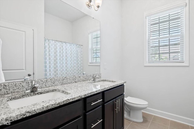 7801 Charters End St, Willow Springs, NC 27592 - bathroom featuring plenty of natural light, toilet, tile patterned flooring, and double vanity