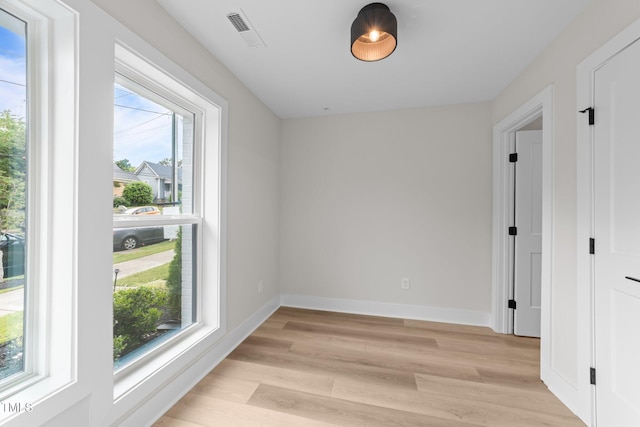 710 W N St Unit 101, Raleigh, NC 27603 - empty room with plenty of natural light, light wood finished floors, and baseboards