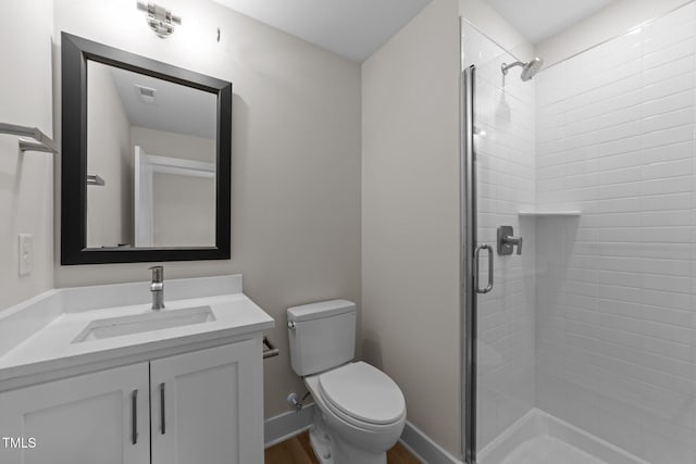 710 W N St Unit 101, Raleigh, NC 27603 - full bath featuring vanity, a stall shower, toilet, and wood finished floors