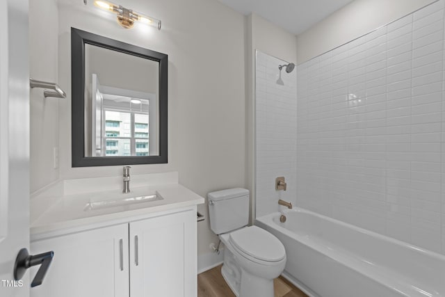 710 W N St Unit 101, Raleigh, NC 27603 - bathroom featuring toilet, wood finished floors, vanity, and washtub / shower combination