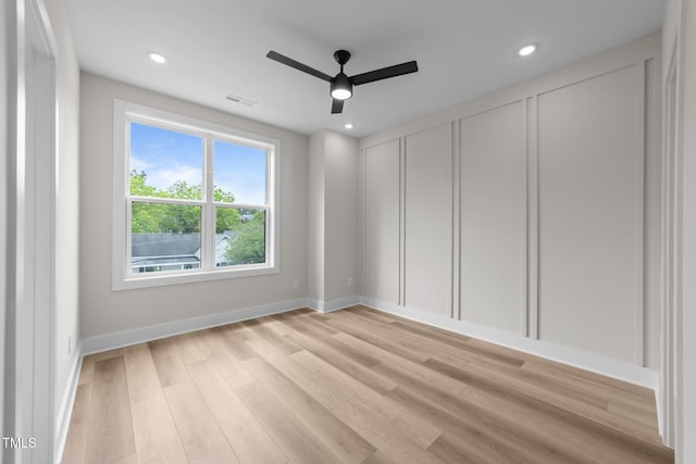 710 W N St Unit 101, Raleigh, NC 27603 - spare room with a ceiling fan, light wood-type flooring, baseboards, recessed lighting, and a decorative wall