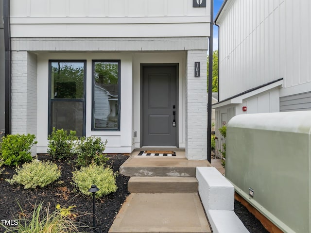 710 W N St Unit 101, Raleigh, NC 27603 - view of exterior entry with brick siding and board and batten siding